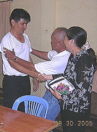 Pastor Quang being greeted at home